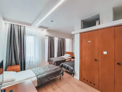a hotel room with two beds and a cabinet at Motel West in Zenica