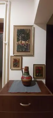 a vase sitting on top of a wooden table at Apartman EXCLUZIV in Prijedor