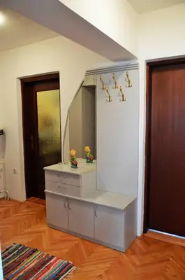 a dresser with a mirror in a room at Apartman EXCLUZIV in Prijedor