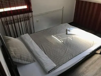 a bed in a bedroom with a mattress and pillows at Apartman EXCLUZIV in Prijedor