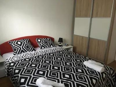 a bedroom with a black and white comforter and a bed at Luxury apartment in the heart of Jajce in Jajce