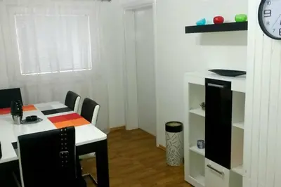 a room with a table and chairs and a clock at Luxury apartment in the heart of Jajce in Jajce