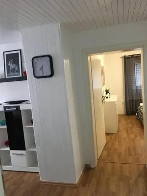 a clock on a wall next to a room at Luxury apartment in the heart of Jajce in Jajce
