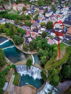 an aerial view of a city with a waterfall at Luxury apartment in the heart of Jajce in Jajce
