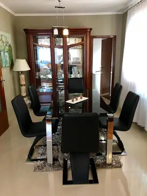 a living room with black chairs and a table at Apartments Dreams Centar in Živinice