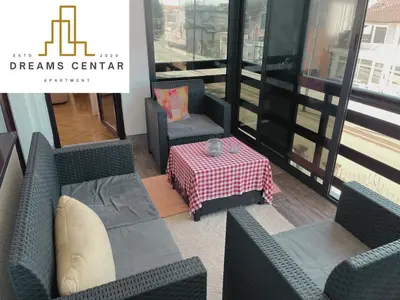 a room with chairs and a table with a table at Apartments Dreams Centar in Živinice