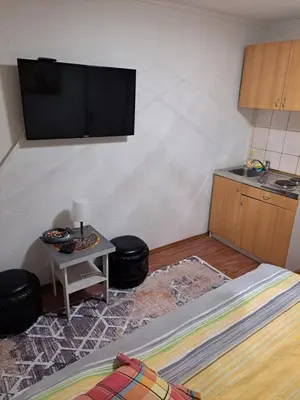 a room with a flat screen tv on a wall at Apartmani Konta in Livno
