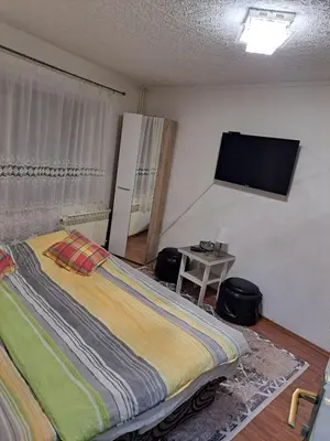 a bedroom with a bed and a flat screen tv at Apartmani Konta in Livno