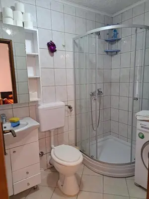 a bathroom with a shower and a toilet and a sink at Apartmani Konta in Livno