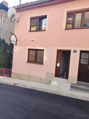 a pink building on the side of a street at Apartmani Konta in Livno