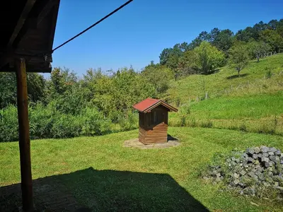 a small wooden out house on a grass field at Katarina Doboj,Bušletić in Busletić