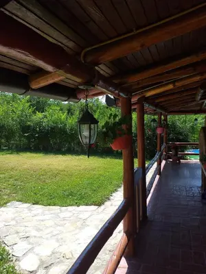 a wooden pergola with a light hanging from it at Katarina Doboj,Bušletić in Busletić