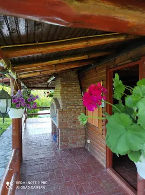 a brick house with flowers on the side of it at Katarina Doboj,Bušletić in Busletić
