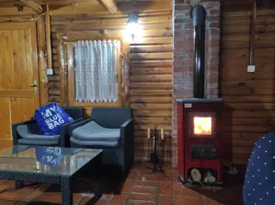 a living room with a wood stove in a cabin at Katarina Doboj,Bušletić in Busletić