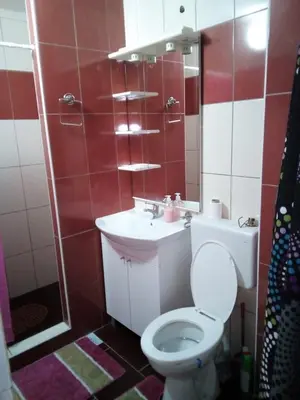 a bathroom with a toilet and a sink at Lara in Doboj