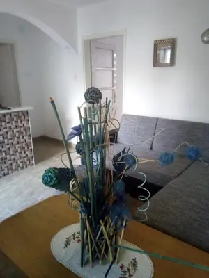 a room with a vase with blue flowers in it at Lara in Doboj
