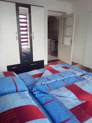 a bedroom with two beds with blue and red blankets at Lara in Doboj