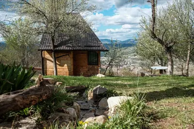 a small log cabin in the middle of a field at Bungalows Old Town in Visoko