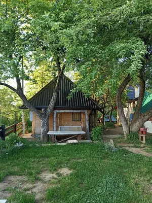 a log cabin with a picnic table and trees at Bungalows Old Town in Visoko