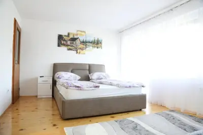 a small bedroom with a bed and a window at Apartment Stanic in Šipovo