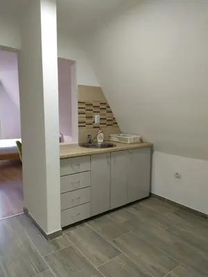 an empty kitchen with a sink and a staircase at Apartment Stanic in Šipovo