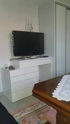 a flat screen tv sitting on top of a white dresser at Villa Happy dreams in Bihać
