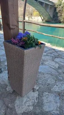a basket of flowers is sitting on the ground at ATRIUM Holiday home in Bihać