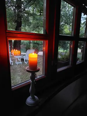 a candle sitting on a table in front of a window at ATRIUM Holiday home in Bihać