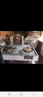 a kitchen with a grill with some pizzas on it at ATRIUM Holiday home in Bihać