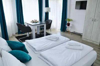 a living room with a white couch and a table at Guesthouse Marivo in Jajce