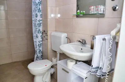 a bathroom with a toilet and a sink at Guesthouse Marivo in Jajce