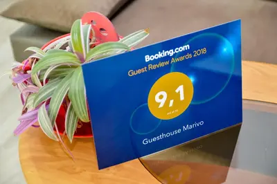 a blue sign on a table with a plant at Guesthouse Marivo in Jajce