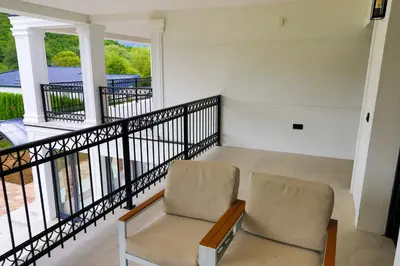 a room with two chairs and a balcony at Casa Dellˇ Amore in Bihać