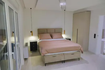 a bedroom with a large bed in a white room at Casa Dellˇ Amore in Bihać