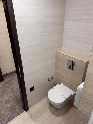 a bathroom with a white toilet in a room at Villa Aroma 2 in Orašje