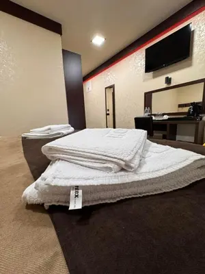 a bedroom with a bed with a price tag on it at Villa Aroma 2 in Orašje