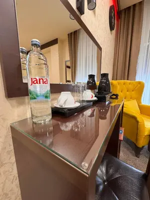 a bottle of water sitting on top of a table at Villa Aroma 2 in Orašje