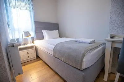 a small bedroom with a bed and a window at So&sol boutique Hotel, Tuzla in Tuzla