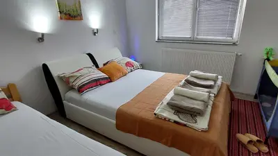 a bedroom with a bed with towels on it at Apartments Window in Bihać