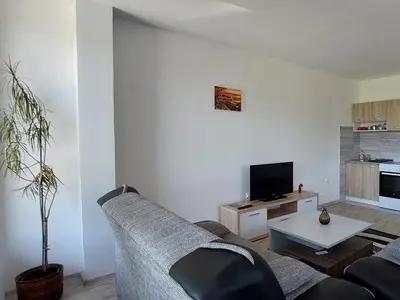a living room with a couch and a tv at Apartments Window in Bihać