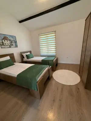 a bedroom with two beds and a window at Family estate Hadžalova avlija in Bihać