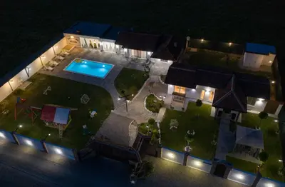 an aerial view of a backyard at night with a swimming pool at Family estate Hadžalova avlija in Bihać