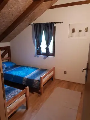 a bedroom with two beds and a window at Village Gečat-Villa Una in Kulen Vakuf