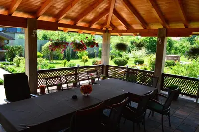 a large black table and chairs on a porch at Una Valley Bihać in Bihać