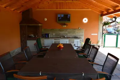 a dining room with a long table and chairs at Una Valley Bihać in Bihać