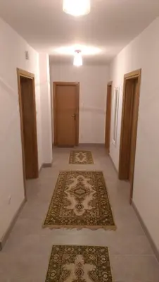 an empty hallway with two rugs on the floor at Peaceful Oasis - house for rest and relaxation in Bosanska Krupa