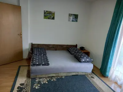 a bed with pillows on it in a room at Peaceful Oasis - house for rest and relaxation in Bosanska Krupa