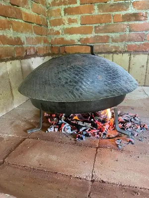 a large grill sitting on top of a fire at Peaceful Oasis - house for rest and relaxation in Bosanska Krupa