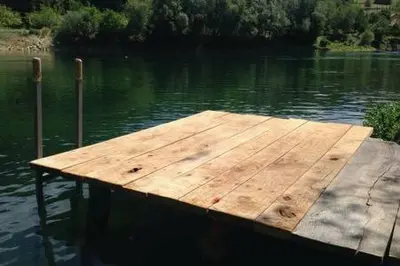 a wooden dock in the middle of a body of water at Peaceful Oasis - house for rest and relaxation in Bosanska Krupa