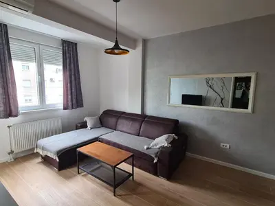 a living room with a couch and a table at Modern apartment in Banja Luka